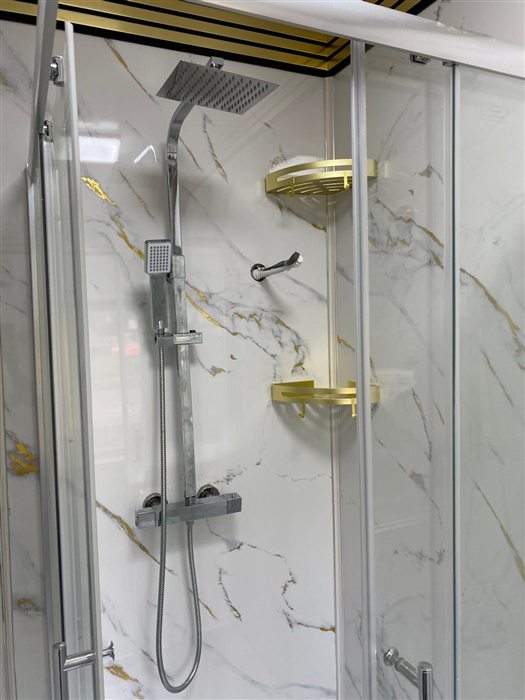Shower enclosure with marble-effect panels and brass shelves