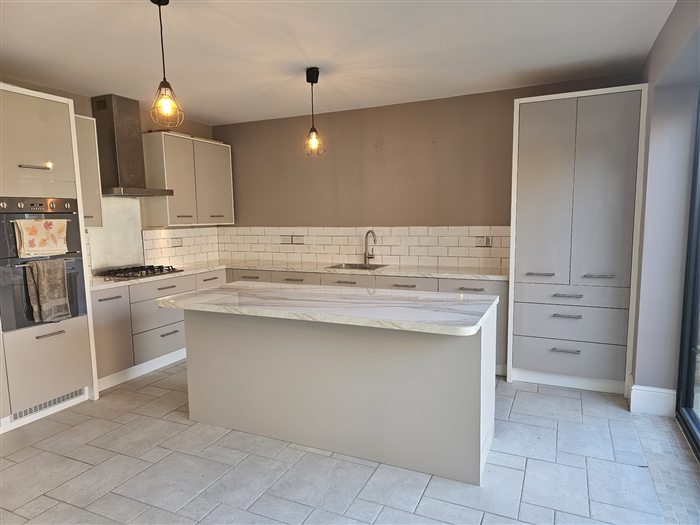 Finished kitchen with island and pendant lights