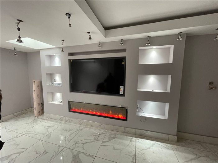 Grey media wall with electric fire and lit niches