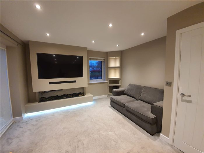 Lounge media wall with LED-lit floating plinth