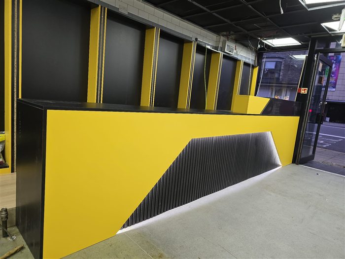 Yellow and black shop counter with LED strip