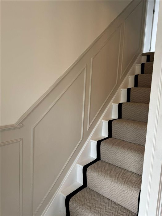 Painted panelling up a staircase