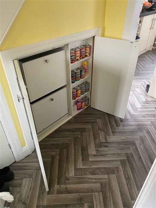 Pull-out storage drawers under a staircase